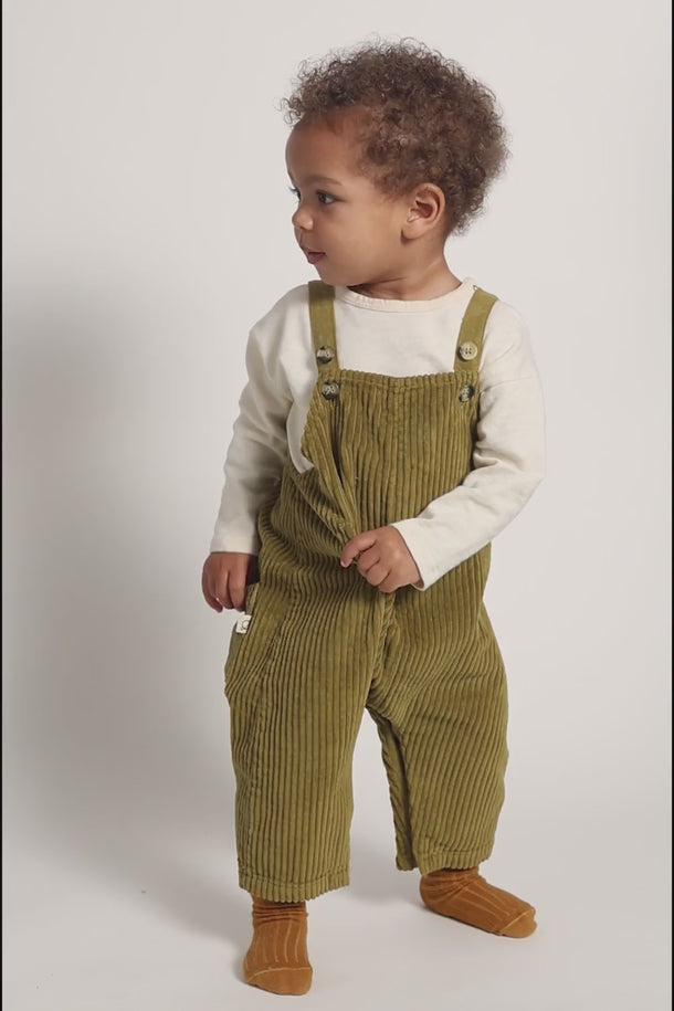 #color_green |  | Toddler boy wearing GOTS-certified organic cotton corduroy overalls in green from Cozmo for a perfect fall outfit