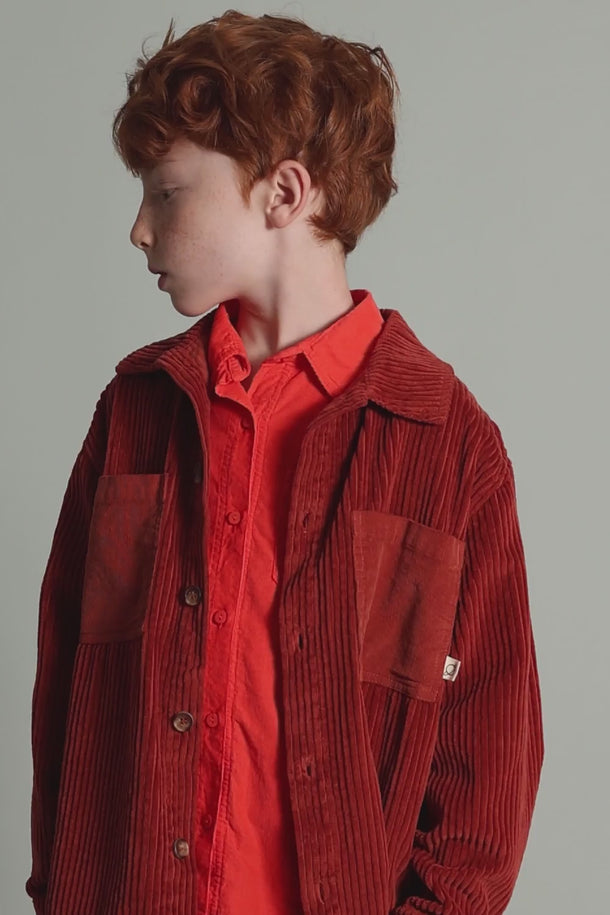 #color_ginger | video of a boy wearing a red gots certified organic cotton outfit from cozmo