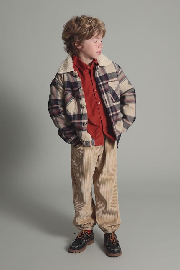 #color_stone | boy wearing gots organic cotton certified corduroy pants in beige from cozmo