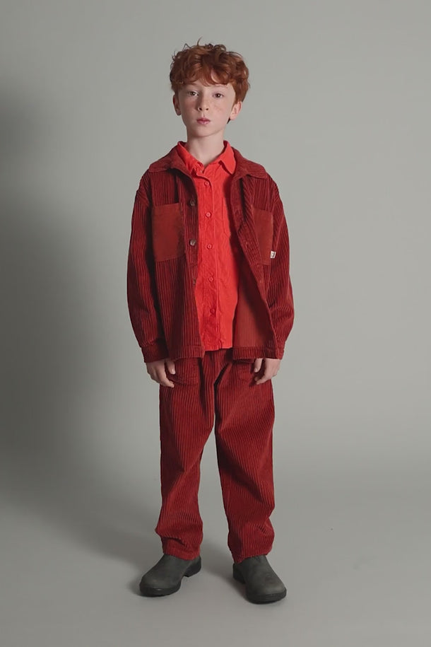 #color_ginger | boy showing how to style gots and oeko-tex certified organic cotton wide wale corduroy pants in red from cozmo